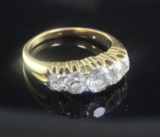 An early 20th century gold and graduated five stone diamond ring, size P.